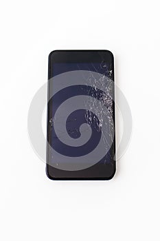 Black mobile phone with a broken screen on a white background close-up