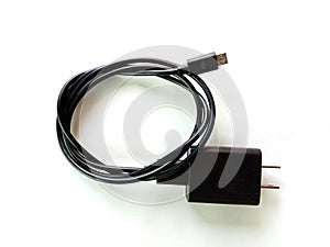 Black mobile phone cord AC charger and USB cable.