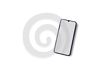 Black mobile smartphone mockup lies on the surface with blank screen isolated on white background