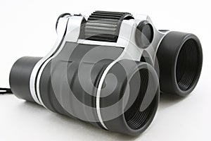 Black modern binoculars, laying flat