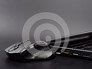 Black modern computer mouse on dark background