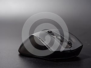 Black modern computer mouse on dark background