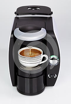 A black modern espresso coffee machine is making a coffee