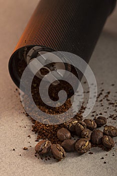 Black modern manual coffee grinder and beans