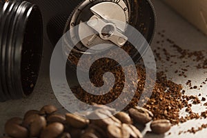 Black modern manual coffee grinder and beans