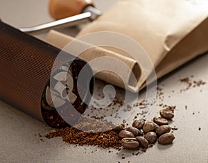 Black modern manual coffee grinder and beans