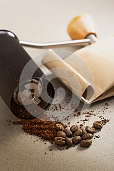 Black modern manual coffee grinder and beans