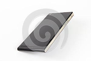 Black modern smartphone with blank screen lies on the surface, h