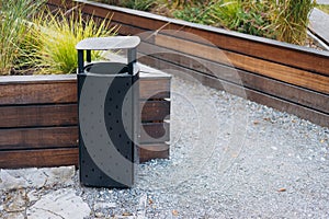 black modern trash bin in the park.