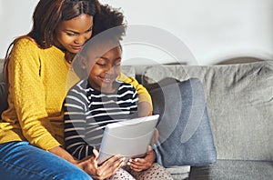 Black mom and child with tablet