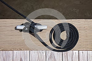 Black Mooring Rope Knotted to a Sliver Cleat