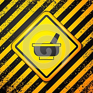 Black Mortar and pestle icon isolated on yellow background. Warning sign. Vector