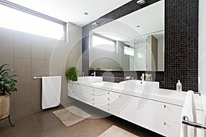 Black mosaic tiled splashback and double basin bathroom