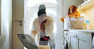 Black mother, child and hide in laundry basket, surprise and having fun in home together. African mom, cleaning and kid