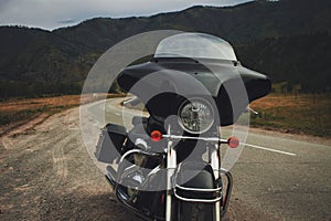 Black motorcycle bagger on the roadside photo
