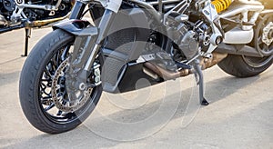 Black motorcycle on the running board parked