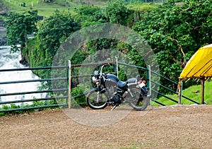 Black Motorcyle Parked Outdoor, Near Waterfall photo