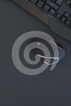 Black mouse, keyboard isolated on a dark background, top view. Flat lay gamer background