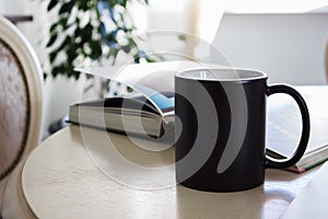 Black mug, cup on a table, Mockup