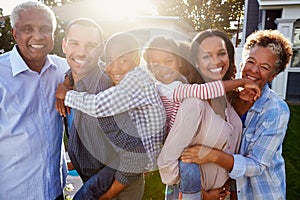 Black multi generation family outside, backlit portrait