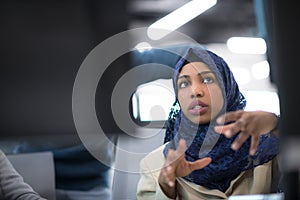 Black muslim female software developer at work