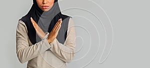 Black muslim woman showing crossed arms gesture, rejection sign