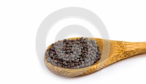 Black Mustard Seeds In Wooden Spoon. White Background. Selective Focus