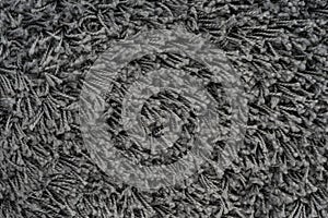 Black natural fleece carpet texture background. Dark wool fabric texture. fragment gray shaggy mat