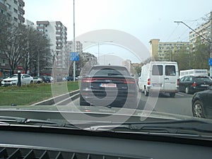 Black new Audi Q8 in traffic. Road view through car windshield, cars on road in traffic in Bucharest, Romania, 2021