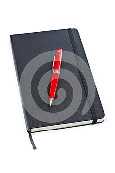 Black notebook and pen