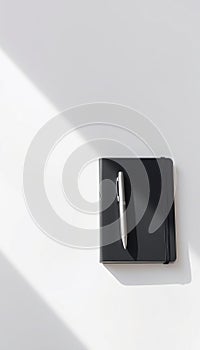 Black Notebook with Silver Pen