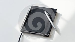 Black Notebook with Silver Pen
