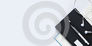Black notebook with White pencil and eraser, black pencil for drawing on a white table, school concept with copy space, Top view,