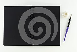 Black Notepad with pen and ink on a white background, isolates