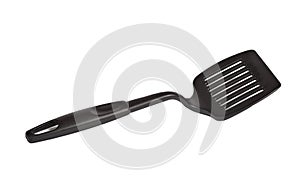 Black nylon slotted turner on white background photo