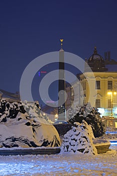 Black obelisk and fountain at Banska Bystrica during winter