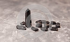 Black obsidian crystal wand. Crystals of stone black tourmaline.