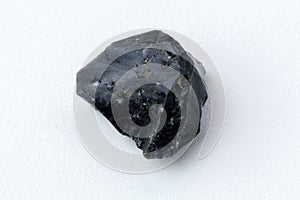 Black Obsidian stone on a white background. Natural glass. Black mineral gem