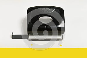 black office hole puncher on a paper