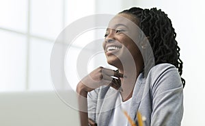 Black Office Lady Laughing Sitting Against Window At Work