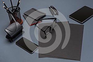 Black office stuff collection flat lay. Top view on set of stationery with smartphone and tablet