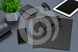 Black office stuff collection flat lay. Top view on set of stationery with smartphone and tablet