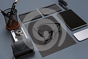 Black office stuff collection flat lay. Top view on set of stationery with smartphone and tablet