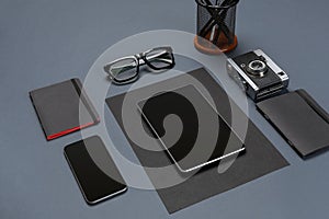 Black office stuff collection flat lay. Top view on set of stationery with smartphone and tablet