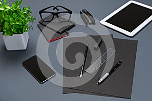 Black office stuff collection flat lay. Top view on set of stationery with smartphone and tablet