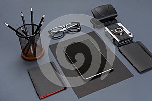 Black office stuff collection flat lay. Top view on set of stationery with tablet