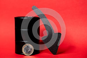 Black oil barrel with a one euro coin and down arrow on a red background