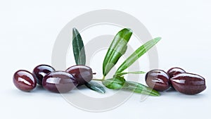 Black Olives with Green Leaves Composition Isolated On White Background