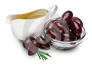 Black olives isolated in glass bowl and oil on white background