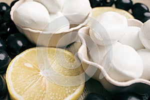 Black olives, mozzarella cheese and lemon slices close-up